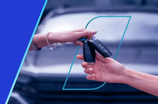 Troca de chaves entre duas mãos, simbolizando a conclusão de um negócio.