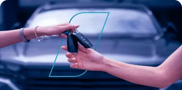 Troca de chaves entre duas mãos, simbolizando a conclusão de um negócio.