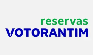 Logotipo 'reservas VOTORANTIM' com 'reservas' em verde e 'VOTORANTIM' em azul sobre fundo branco.